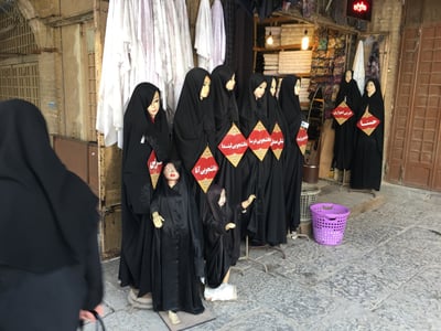 Chadors on display along the shopping street in Mashhad.